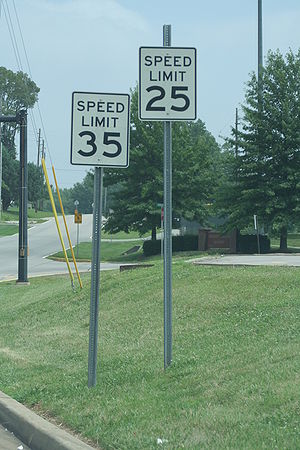An image of two contradictory speed limit signs.